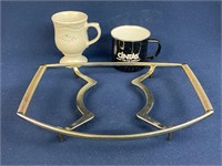 Corning ware trivet, and two coffee cups one is