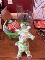 ceramic giraffe, with basket of paper, straws,