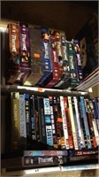 Two white drawers of 28 movie DVDs including many