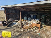 shed full of metal barrels, garden hoses, scrap,