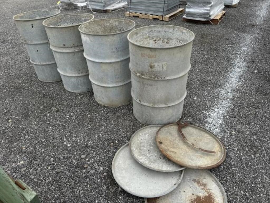 Four metal barrels with lids