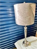 Tall lamp with silver colored shade
