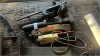 Assortment of tools, clamps, wrench, handsaw