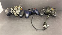 Two original XBox controllers and another