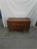 Vintage stereo phonograph cabinet with records
