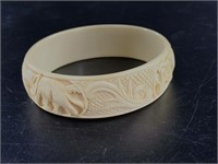 Vintage ivory bangle with elephants carved into it