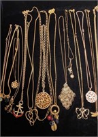 Gold tone necklaces with large pendants