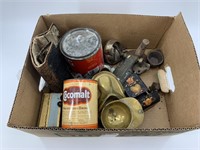 Box with assorted brass items, cast iron trivets,