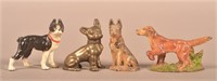 Four Vintage Cast Iron Miniature Dogs.
