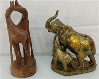 Wooden giraffe carving and resin elephant figure