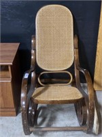 Wicker back rocking chair.