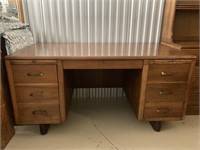 Solid wood desk. Measures L58xW30xH29.25 inches.
