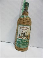 Vintage wicker wrapped tequila bottle