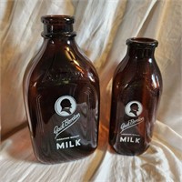 Two Amber Gail Borden Milk Bottles