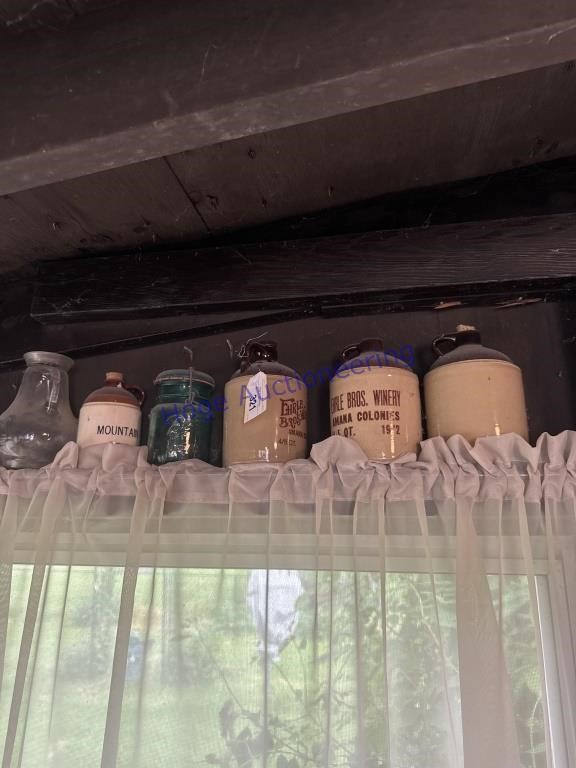 4 SMALL CROCK JUGS, ONE BLUE JAR, ON PATIO