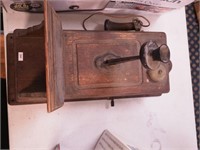 Vintage wall-mounted crank telephone in wooden