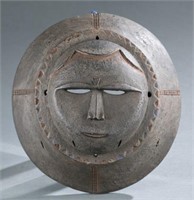 Round carved Eket style mask.