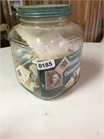 Glass jar full of cancelled stamps