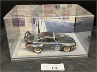 Model Porsche Race Car In Display Case.