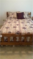 Queen size bed with headboard with bedding and