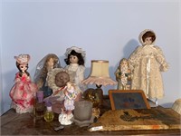 Contents of top of dresser/globe/ porcelain dolls