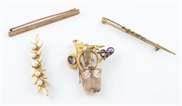 4 Gold brooches.