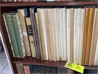 Second shelf of book case, books including Henry t