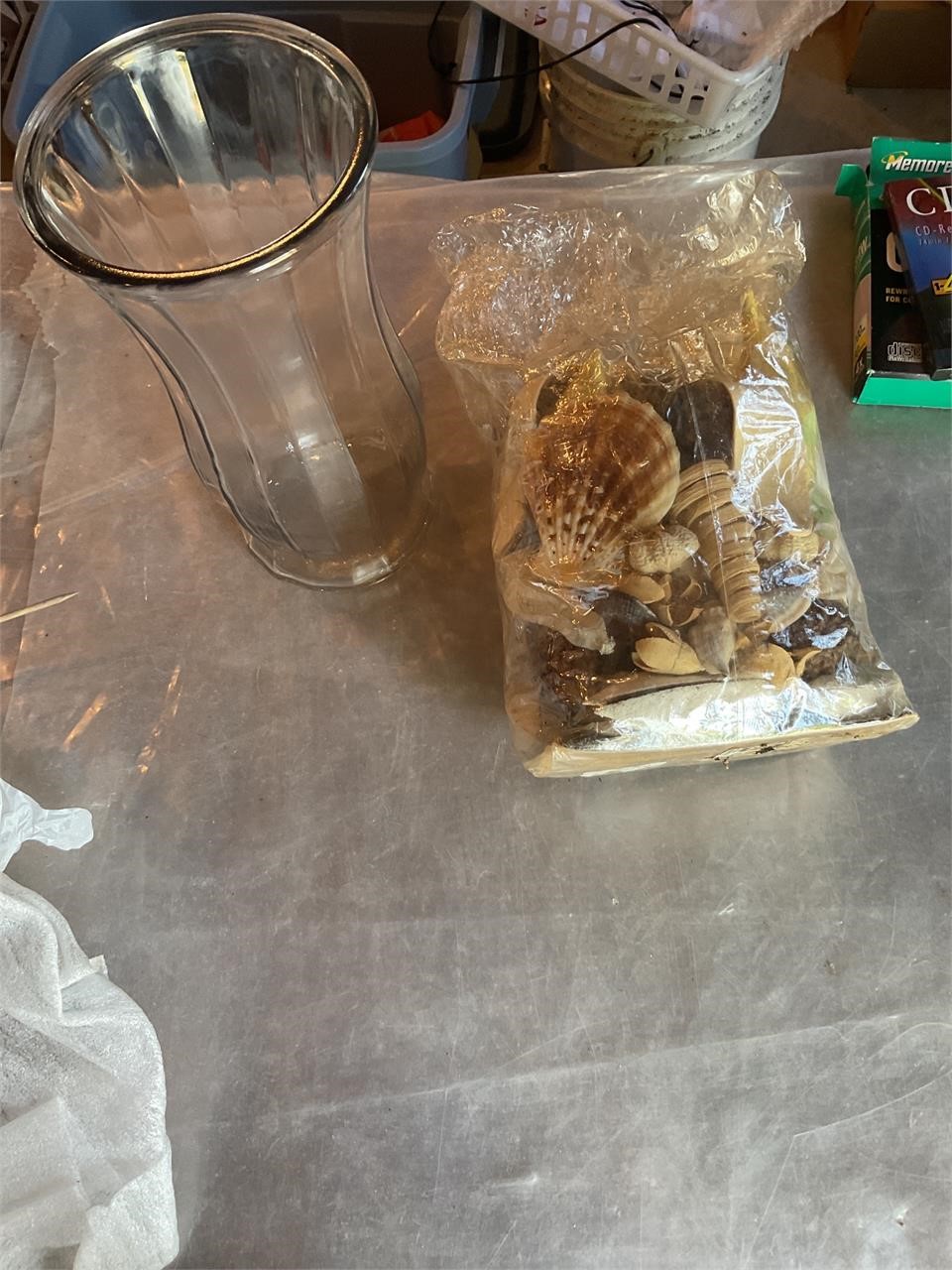 Bag of shells and clear vase