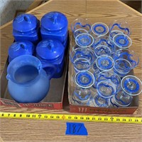 Set of blue canisters with seals, glass pitcher,