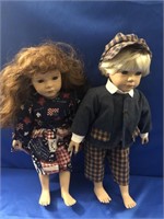 PAIR OF VINTAGE DOLLS. EYES OPEN AND CLOTHES AND