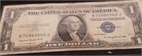 1935 G $1 silver certificate with a protective