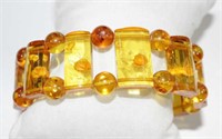 Carved amber coloured stretchy beaded bracelet