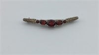 Sterling silver brooch with dark red stones