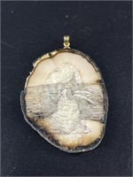 Walrus ivory, intricately scrimmed pendant.