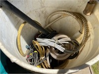 bucket of electrical cords, zip ties and hoses