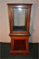 Early single door display case and pine pedestal
