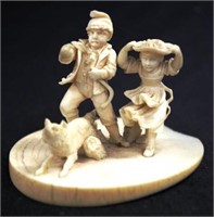 Antique carved ivory couple with dog figure