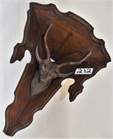 Walnut corner shelf, carved stag