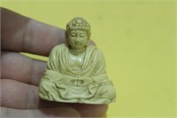 A Japanese Carved Resin God Figurine