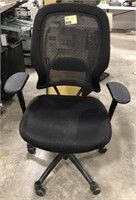 Black computer chair on wheels with arm rests and