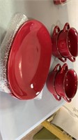 Four red dinner plates, four red chili bowls