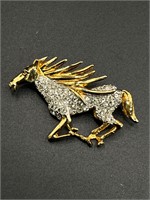 Signed gold toned horse brooch