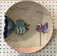 Clay 3-D wall art features two fish and is shaped