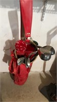 Red gold bag with 2 drivers, 4 irons 1 putter
