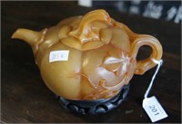 Brown stone carved teapot in the form of a pumkpin