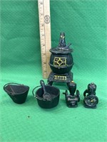 Toy cast iron potbelly stove with pots and salt