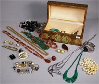 A box of various vintage costume jewellery