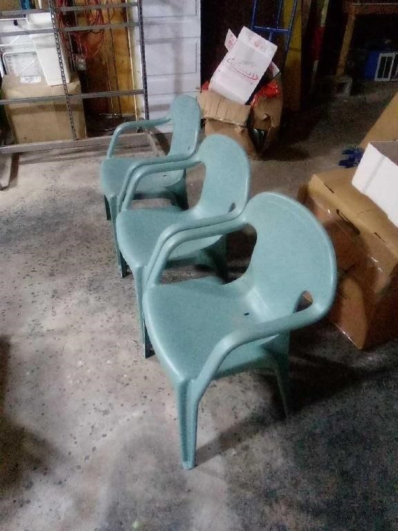 3 green plastic patio chairs. Each measure