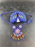 An intricately beaded coin purse with necklace in