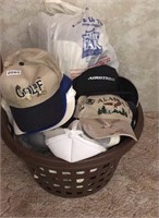 Basket full of  ball hats golf hats etc.